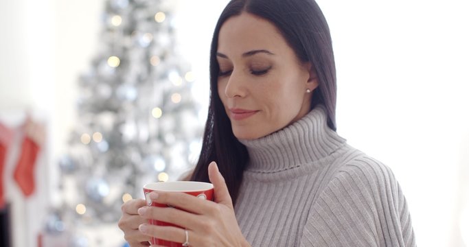 Woman enjoying a cup of Christmas coffee