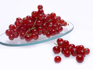 Close up of a glass dish with fresh cranberries, white background