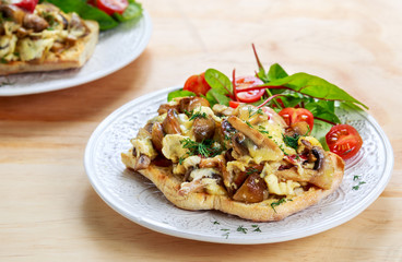 Rustic Morning Breakfast, toast with mushrooms, cheese omelette and fresh vegetables