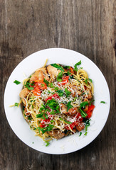 Italian Chicken Breast spaghetti with red pepper, Parmesan cheese and wild rocket  lives. on old wooden table.