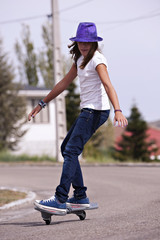 Girl playing with a wave board. Skateboard