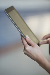 tablet in female hands closeup