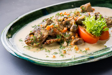 seabass fish baked with vegetables, herbs and lemon, close-up