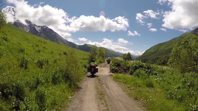 Motorcycles riding on Zagar Pass dirt road high up in the Caucasus Mountains in Georgia