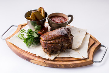roasted pork knuckle with potatoes with sauce