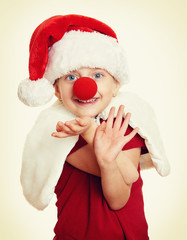 girl in santa hat with clown nose on white isolated