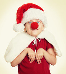 girl in santa hat with clown nose on white isolated