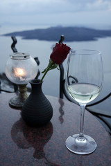 a vine glass and a rose on greece island