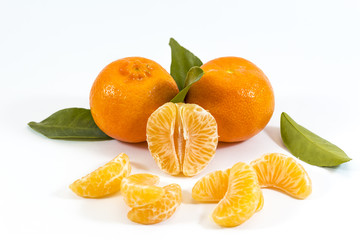 Three mandarines with wedges