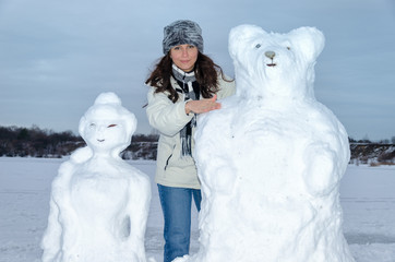 Brunette Caucasian woman with snow sculpture