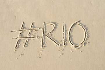 Hashtag social media message for Rio written in smooth sand on the beach in Rio de Janeiro, Brazil
