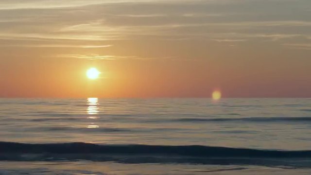 Time lapse of sun setting over the Baltic sea, cirrus clouds