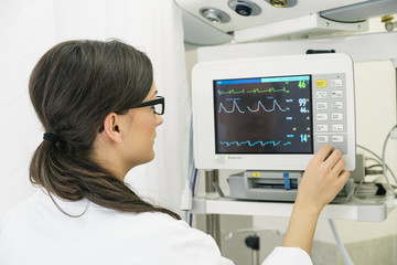 Medical doctor making ECG test in hospital.