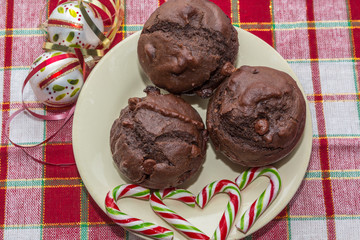 plate of chocolate cupcakes with candy canes and christmas decorations