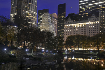 Obraz premium Manhattan skyline at night, with illuminated commercial and residential buildings, New York City