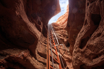 interior of cave with iron ladder in red sandstone