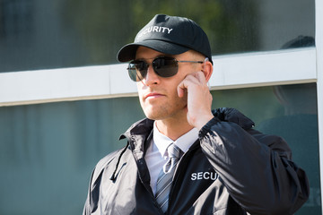 Young Security Guard Standing In Front Of The Entrance