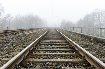 Fototapeta na wymiar Railways leading to the hazy horizon
