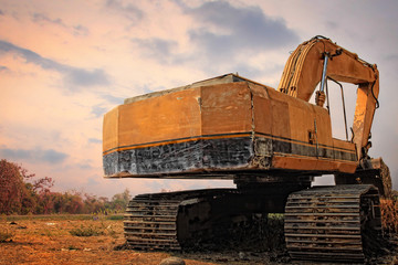 Old excavator on a field