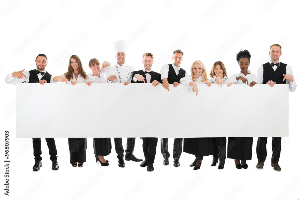 Wall mural Confident Restaurant Staff Holding Blank Billboard