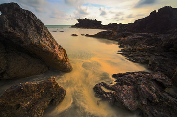 Detail of rock on beach during sunset