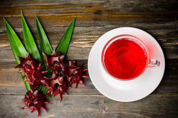 Fresh roselle juice (healthy drink) on wooden background