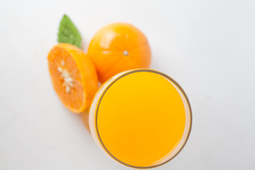 Orange juice and slices of orange isolated on white