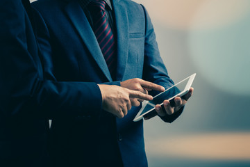 two businessmen using tablet-pc : filtered process