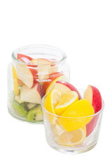 Fresh lemon slice and red apple slice in cup of glass