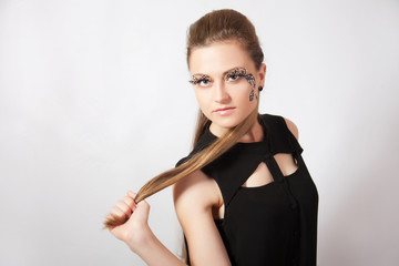 Fototapeta premium Beautiful woman with big eyelashes and face-art
