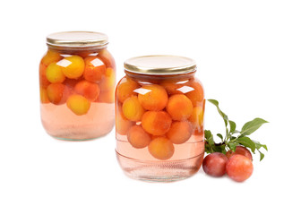 Jar of cherry plum compote on a white background