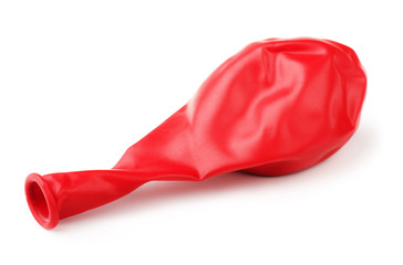 Deflated red rubber balloon