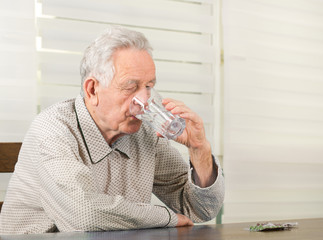 Fototapeta premium Old man taking medicals