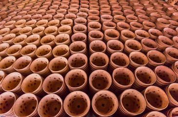 Products containing orchid pots made from clay are reading sun drying in preparation for sale to the market in the pottery village of Binh Duong, Vietnam