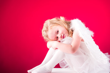Beautiful blond hair angel on a red background