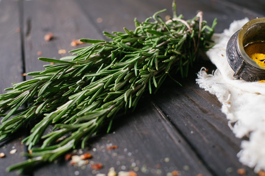 Rosemary on a black wooden background with a free space 