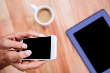 Overhead of feminine hands using smartphone