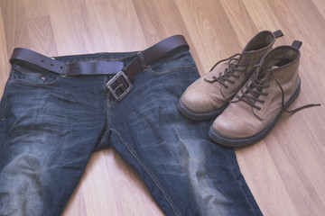  jeans and boots on wooden background