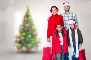 Composite image of  happy family looking at camera 