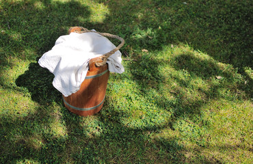 A bucket covered with a white cloth