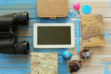 Travel background - binoculars, sunglasses, box, globe, pin, key, padlock, label tag and notebooks