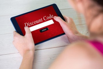 Composite image of woman using tablet at home