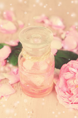 Obraz na płótnie Canvas Rose oil in bottle on light background