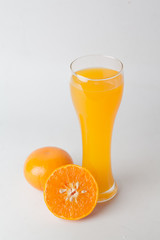 Orange juice and slices of orange isolated on white