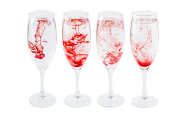 Full wineglasses with red stains isolated on a white background