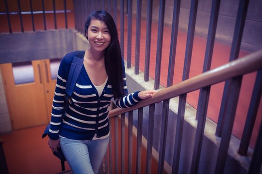 Smiling student walking up steps