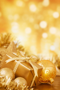 Golden Christmas decorations in front of defocused lights
