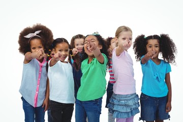 Line of girls standing with hands pointing ahead