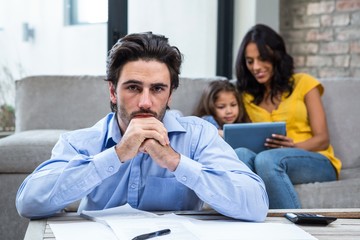 Worried father in living room looking at the camera
