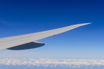 Airplane flying over clouds